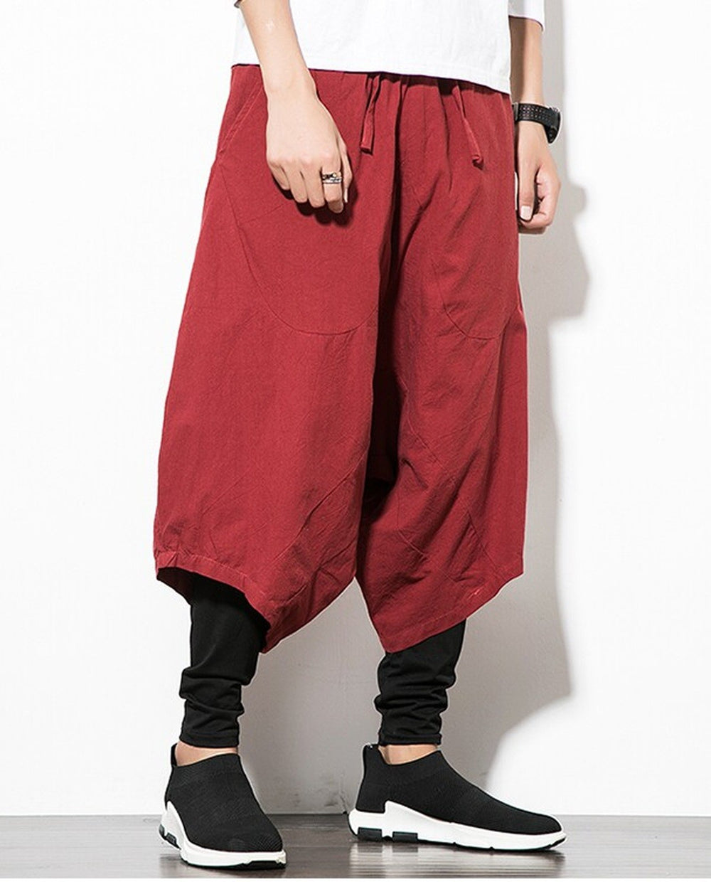 Wine red layered harem pants in motion, showing the low crotch and the fitted black inner leg