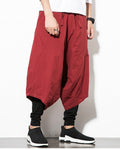 Wine red layered harem pants in motion, showing the low crotch and the fitted black inner leg
