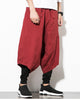 Wine red layered harem pants in motion, showing the low crotch and the fitted black inner leg