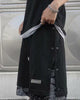 Front of the black snap-side shorts with a drawcord waist, woven label and paisley layer below the hem