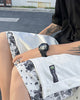 Seated man in the white snap-side shorts, showing the woven label, metal snaps and paisley layer at the hem