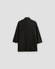 Back of the black linen haori cardigan with a small stand collar and a centre seam