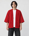Model wearing the red linen haori cardigan open over a white tee and black jeans, front view