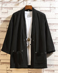 Black linen haori cardigan hanging open over a white tee, showing the patch pockets and the cloth toggle