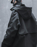 Back three-quarter view of the black hooded jacket showing the hood and the lower back panel