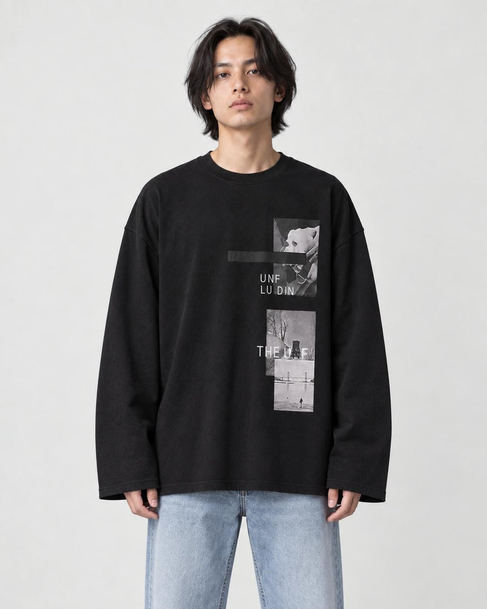 Model wearing the black loose long sleeve tee with a photo print on the chest, light-wash jeans and white sneakers