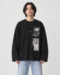 Model wearing the black loose long sleeve tee with a photo print on the chest, light-wash jeans and white sneakers
