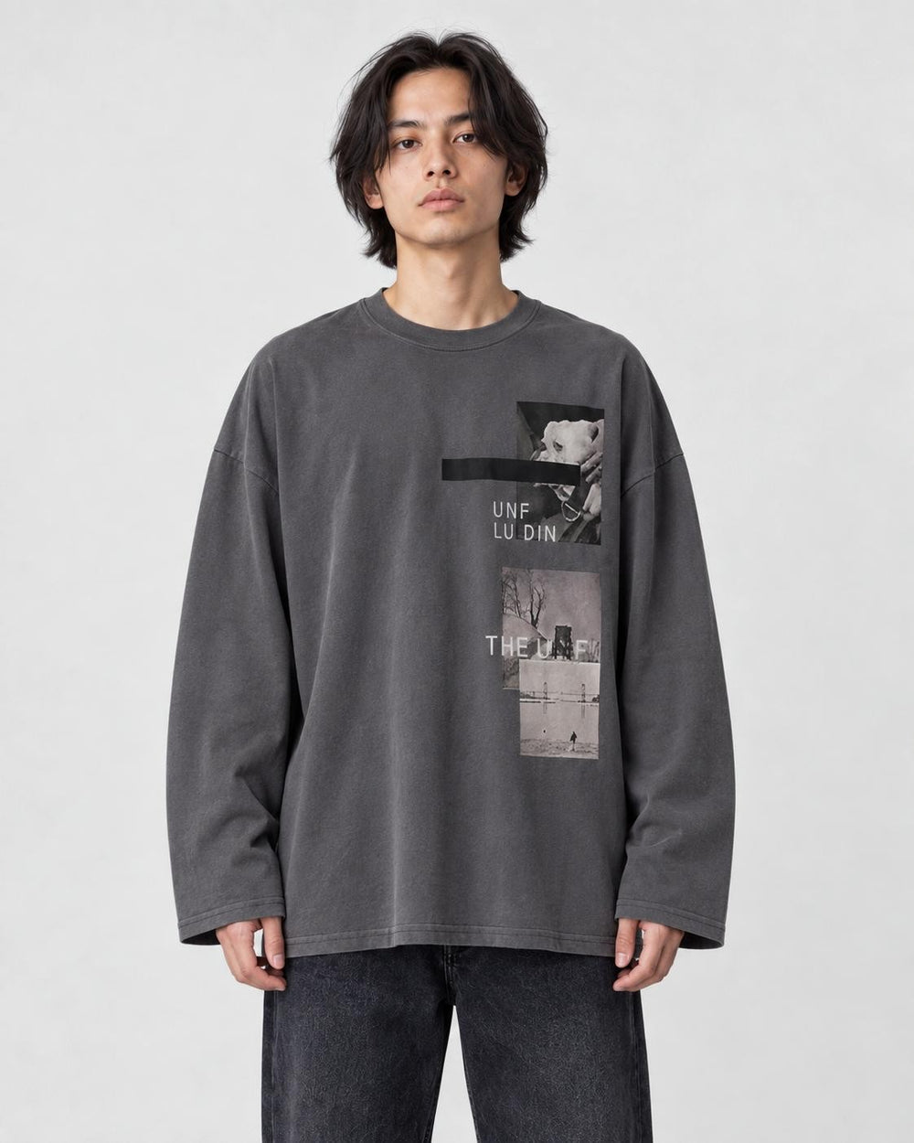 Model wearing the charcoal loose long sleeve tee with a photo print on the chest, dark jeans and white sneakers