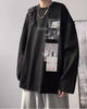 Black loose long sleeve tee with a black bar and two photo panels on the chest, worn with gray sweatpants
