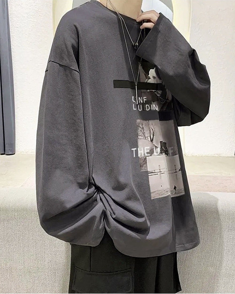 Charcoal loose long sleeve tee, front view, with the photo panels printed on the right chest