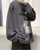 Charcoal loose long sleeve tee, front view, with the photo panels printed on the right chest