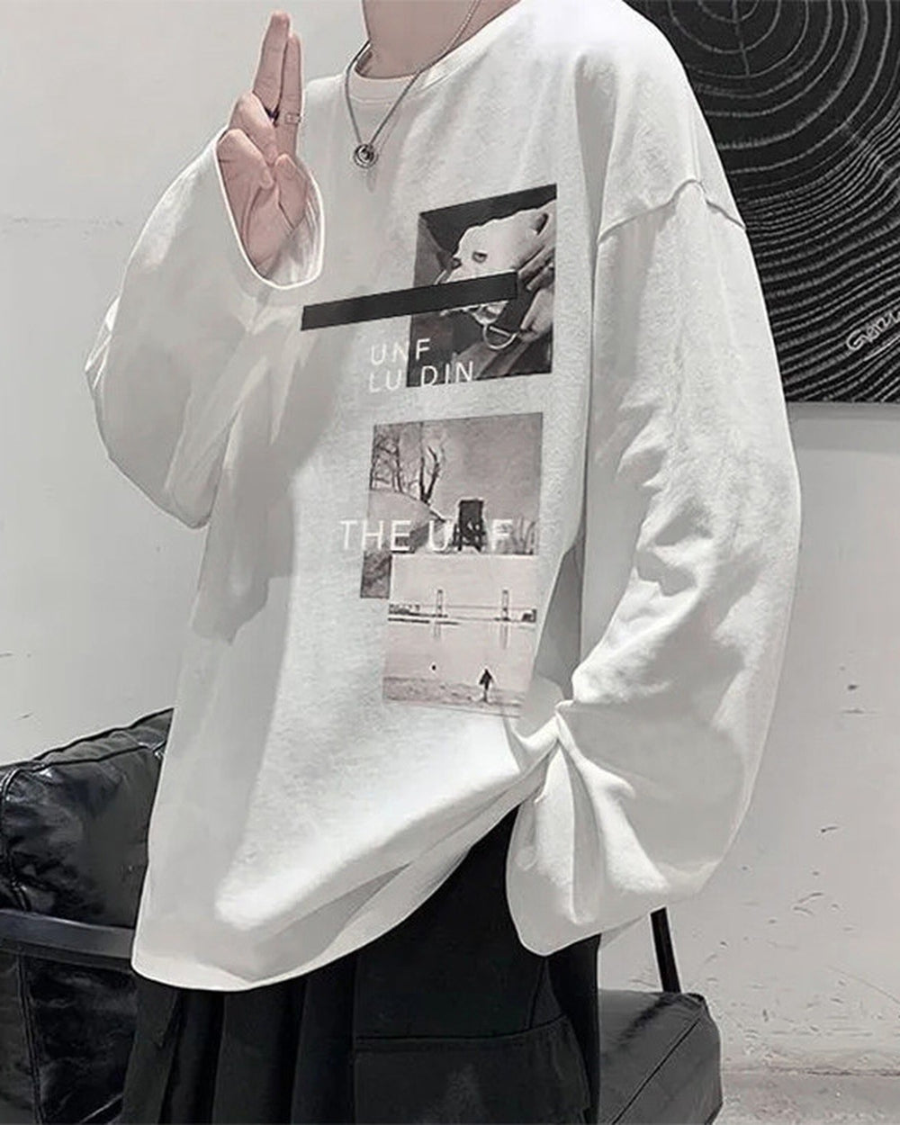 White loose long sleeve tee, three-quarter view, with the white dog photo and the snowy figure photo on the chest