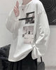 White loose long sleeve tee, three-quarter view, with the white dog photo and the snowy figure photo on the chest