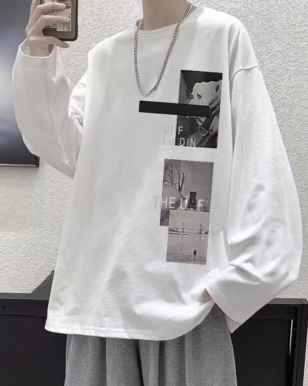 White loose long sleeve tee with a black bar and two photo panels on the chest, worn with a chain necklace