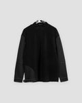 Black mock-neck sweatshirt with waffle-knit body, quilted upper sleeves and gray contrast stitching on a hanger
