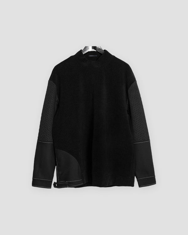 Black mock-neck sweatshirt with waffle-knit body, quilted upper sleeves and gray contrast stitching on a hanger