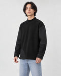 Man in the black mock-neck sweatshirt turned slightly, showing the sleeve panels and stitching