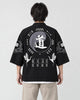 Man seen from behind in a black haori with a large gray 道 circle and two cranes on the back
