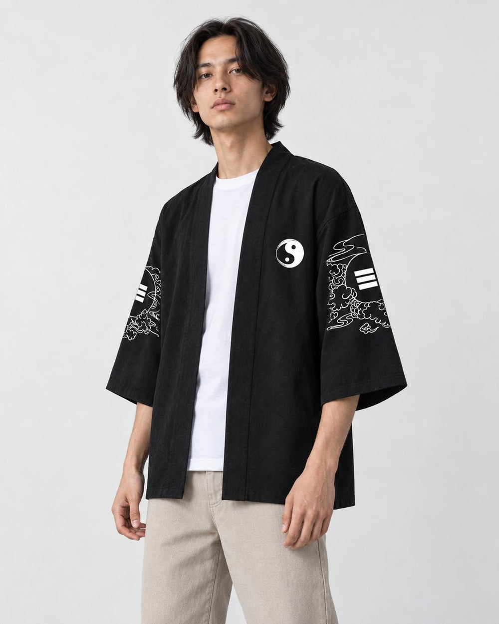 Man in the open black haori over a white tee, turned slightly, showing the sleeve art