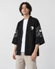 Man in the open black haori over a white tee, turned slightly, showing the sleeve art