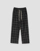 Black plaid wide-leg drawstring pants laid flat, front view