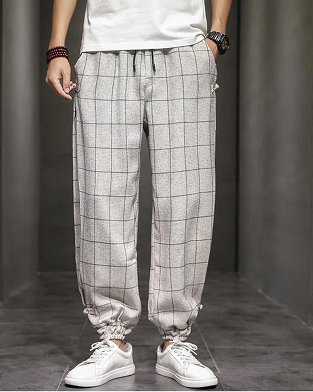 Cream plaid harem pants with frog-button knots at the hips, worn with a white tee and white sneakers