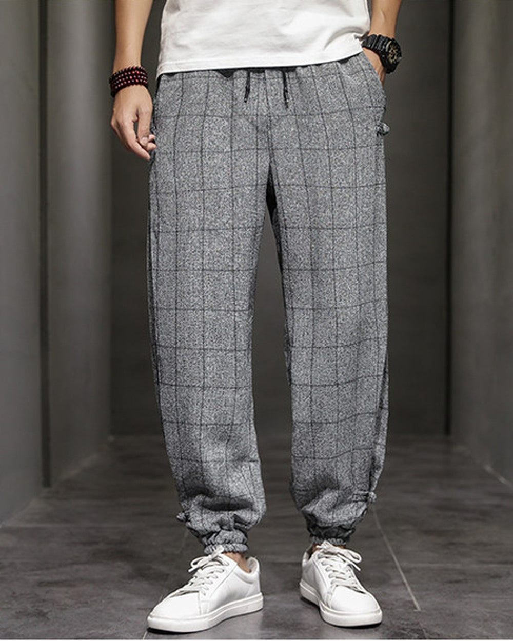 Gray plaid harem pants with frog-button knots at the hips, worn with a white tee and white sneakers