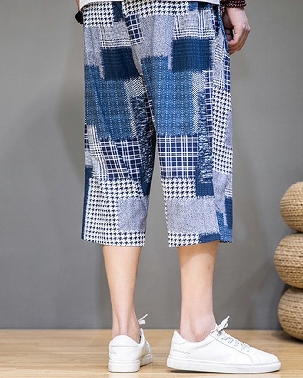 Blue patchwork cropped pants from behind, showing the navy and houndstooth blocks