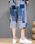Blue patchwork cropped pants from behind, showing the navy and houndstooth blocks