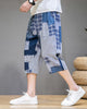 Blue patchwork cropped pants in motion, seen from the side, ending at mid-calf