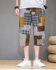 Brown patchwork cropped pants with mustard, plaid and houndstooth blocks, front view