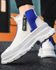 Blue and white platform sneaker boots on foot, close view of the zip pull and the chunky sole