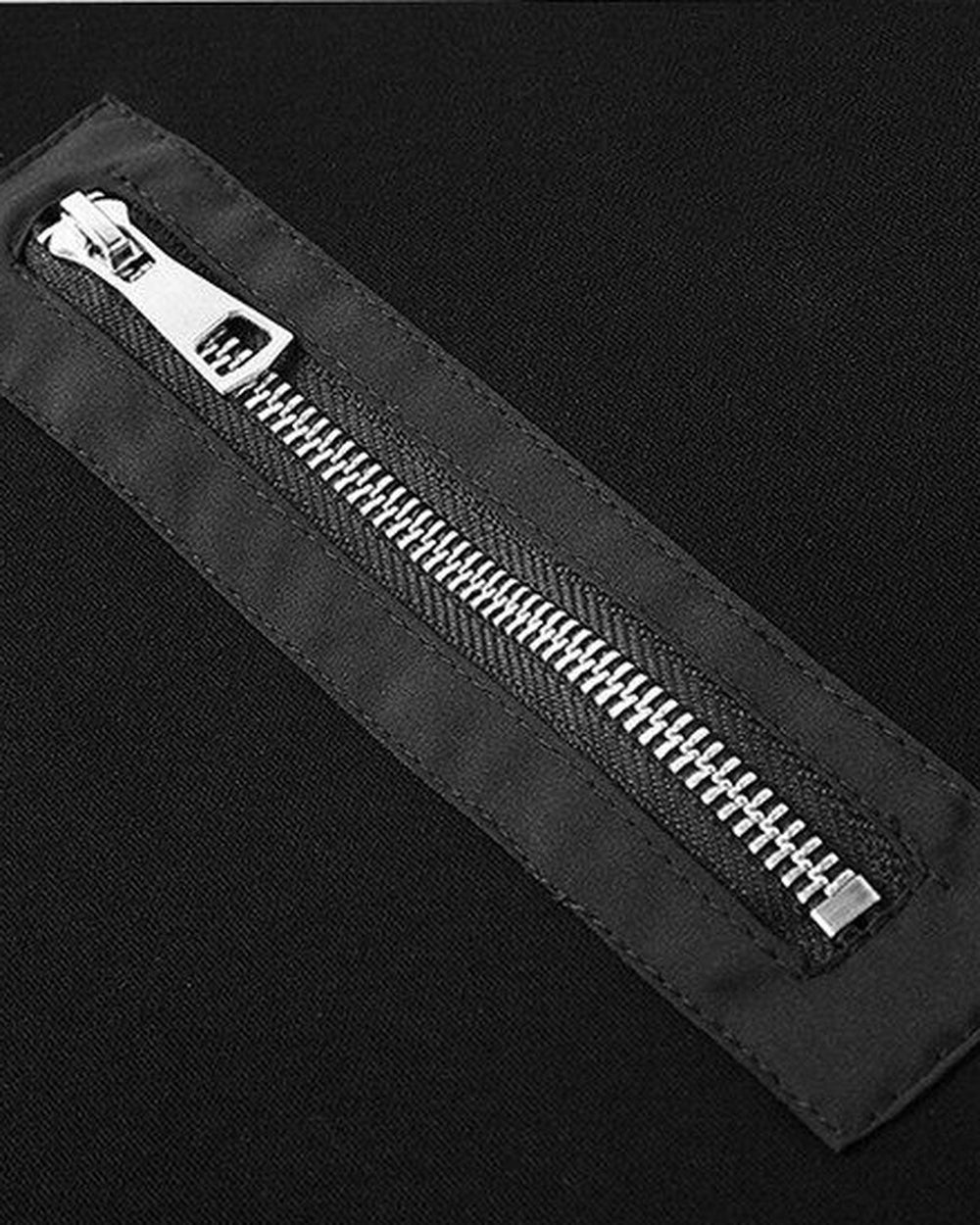Close-up of the diagonal metal zip on the left chest of the black sweatshirt