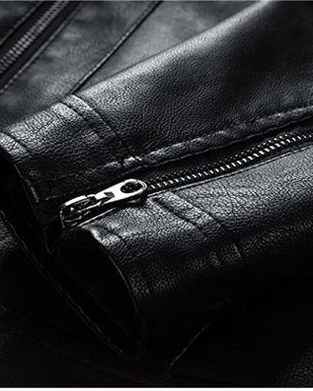 Close-up of the zip on the cuff of the black PU leather jacket