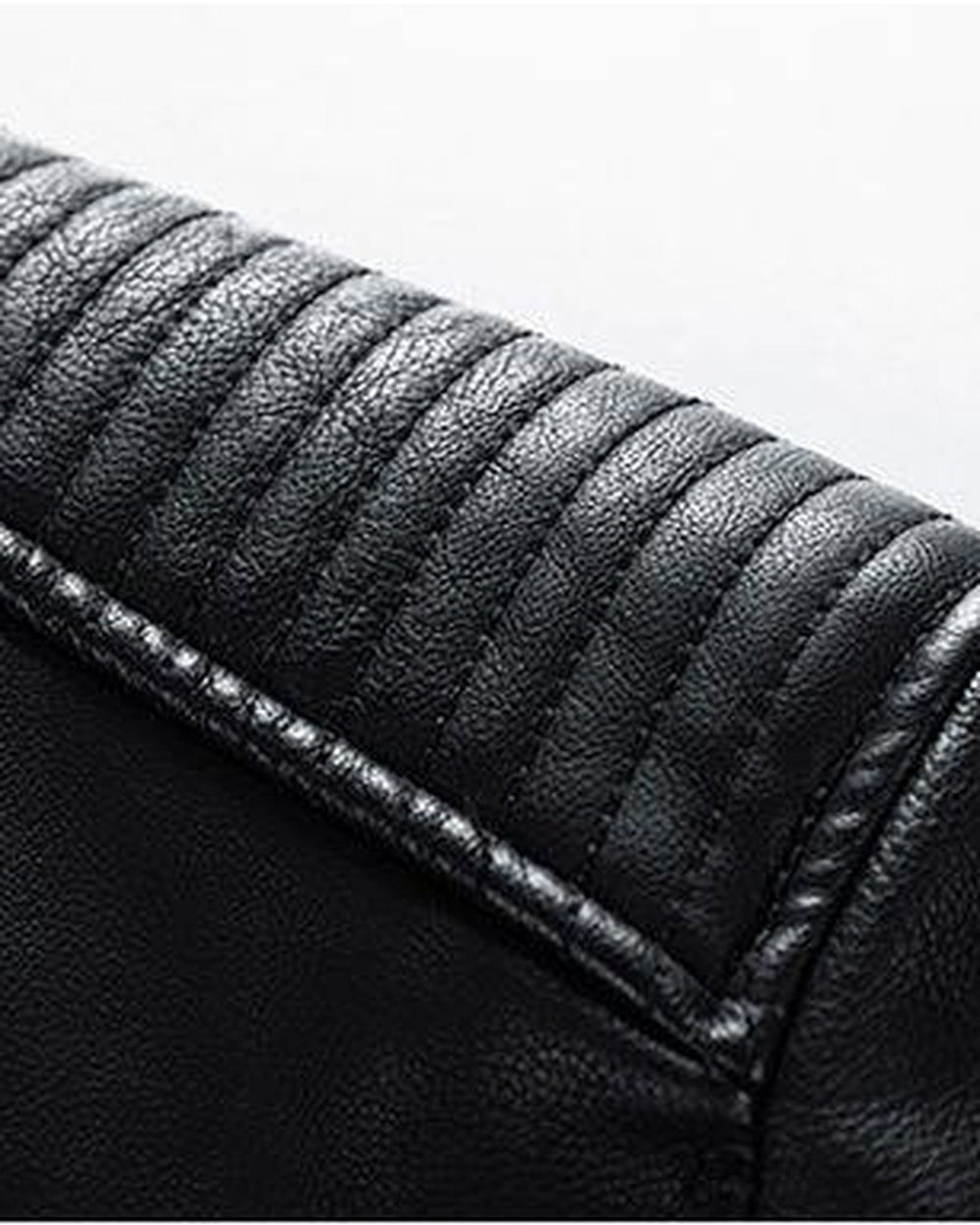 Close-up of the padded shoulder with horizontal ridge stitching on the black PU leather jacket