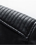 Close-up of the padded shoulder with horizontal ridge stitching on the black PU leather jacket