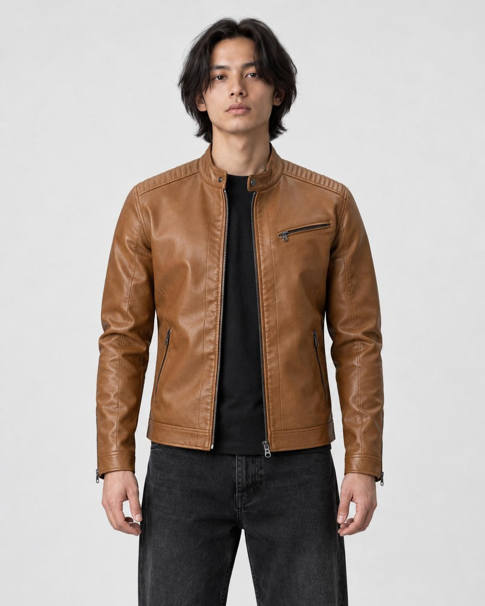 Model wearing the tan PU leather biker jacket with a black tee and black jeans, front view