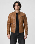 Model wearing the tan PU leather biker jacket with a black tee and black jeans, front view