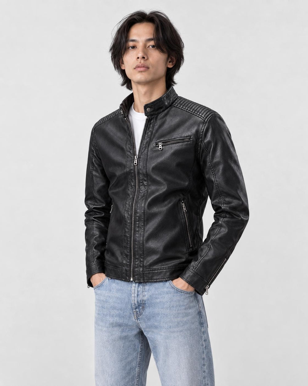 Model wearing the black PU leather biker jacket with a white tee and light-wash jeans, three-quarter view