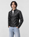 Model wearing the black PU leather biker jacket with a white tee and light-wash jeans, three-quarter view