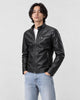 Model wearing the black PU leather biker jacket with a white tee and light-wash jeans, three-quarter view