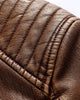 Close-up of the quilted shoulder yoke of the brown PU leather biker jacket