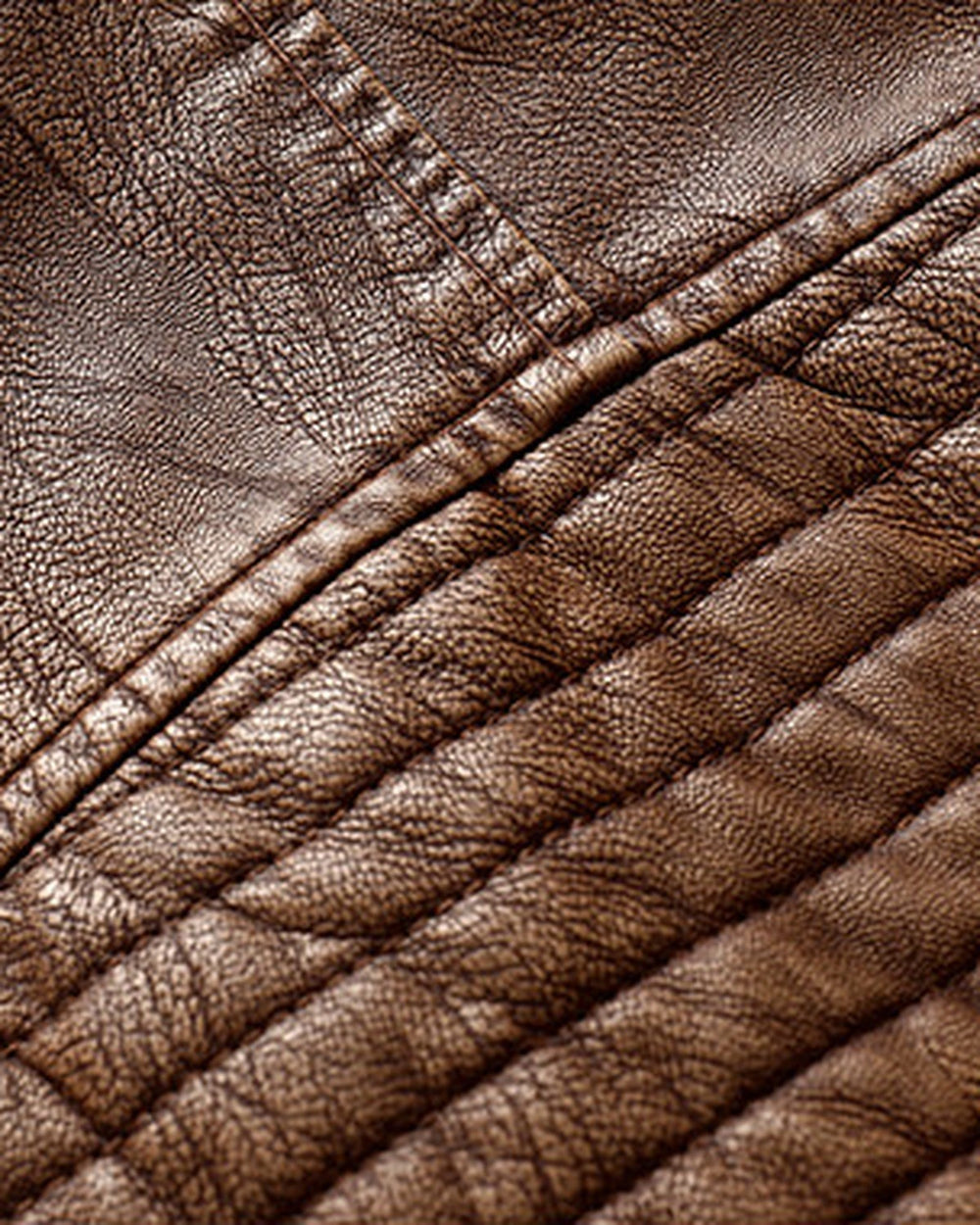 Close-up of the ribbed padding on the upper sleeve of the brown biker jacket