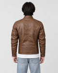 Back of the brown biker jacket on a model, showing the quilted shoulders, centre seam and quilted lower band