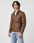 Model wearing the brown PU leather biker jacket over a white tee with light jeans, three-quarter view