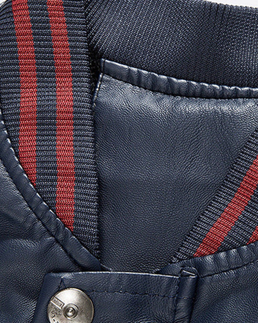 Close view of the striped rib collar and snap on the navy varsity jacket