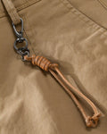 Close-up of the tan cord knotted to a metal snap hook on the belt loop of the khaki chinos