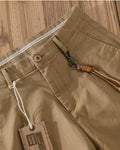 Close-up of the flat waistband, button and fly of the khaki chinos