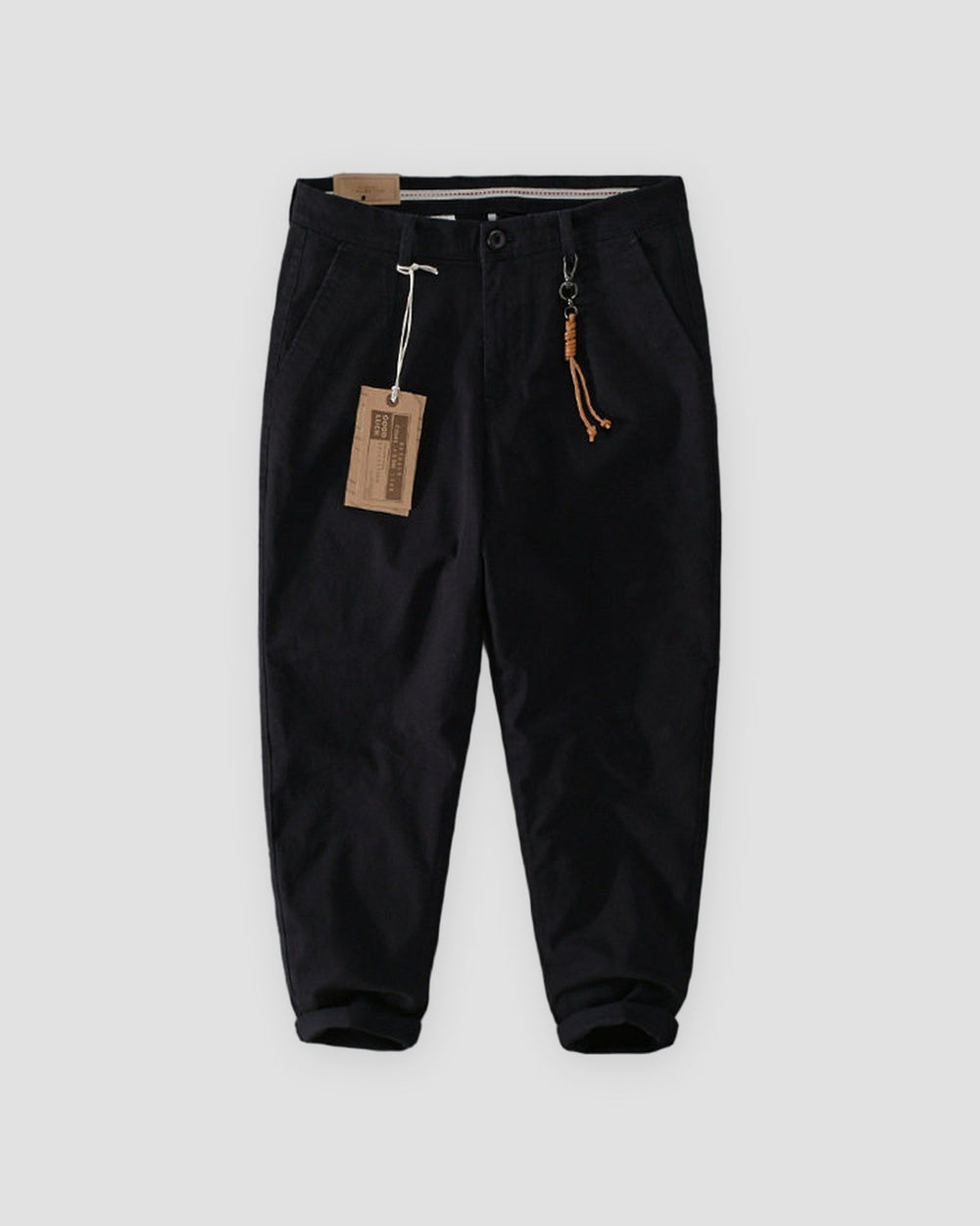 Black cuffed chinos with a tan cord and snap hook on the belt loop, flat view
