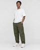 Model wearing the olive green cuffed chinos with a white tee and off-white sneakers, three-quarter view